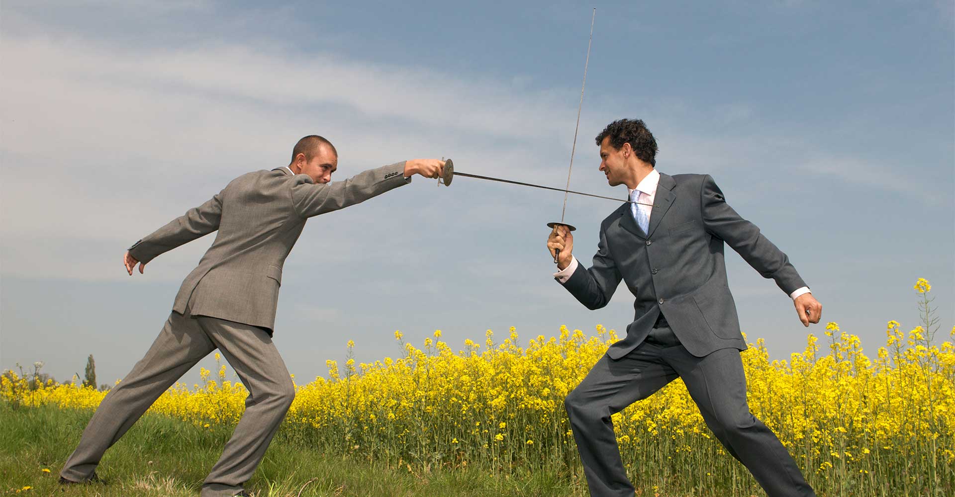 Two men in suits fencing