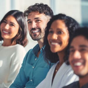 Row of young people smiling in office